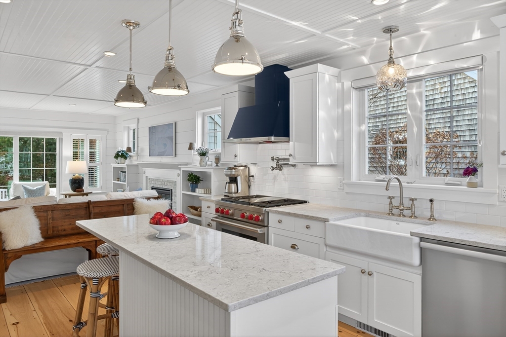 23 Cobblestone Plymouth, MA 02360 - Photo 9 of 39 a kitchen with a sink a stove a dining table and chairs