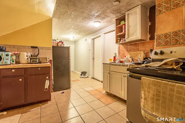 a kitchen with stainless steel appliances granite countertop a sink and cabinets