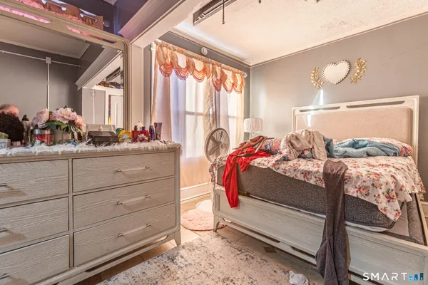 a bedroom with a bed and large windows