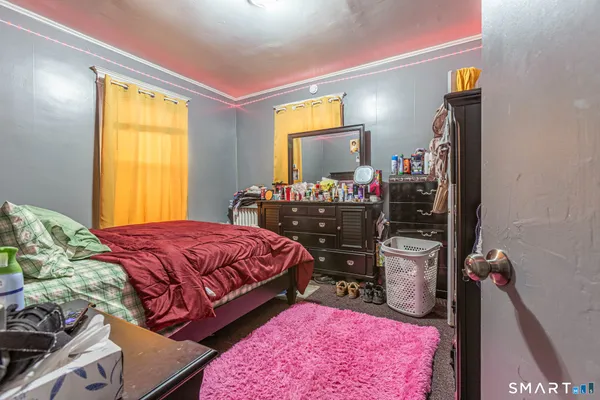 a bedroom with a bed and flat screen tv