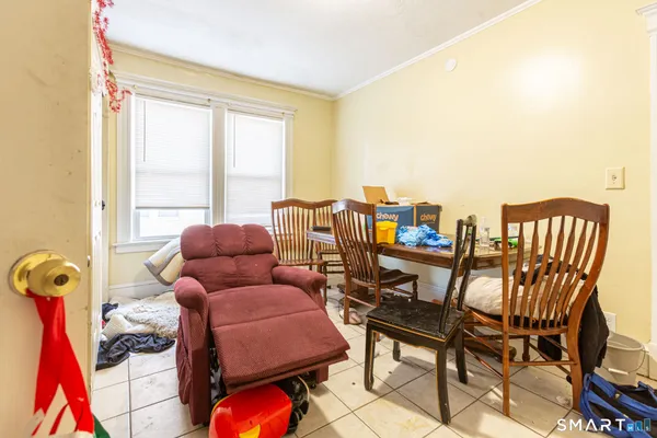 a living room with furniture and a floor to ceiling window