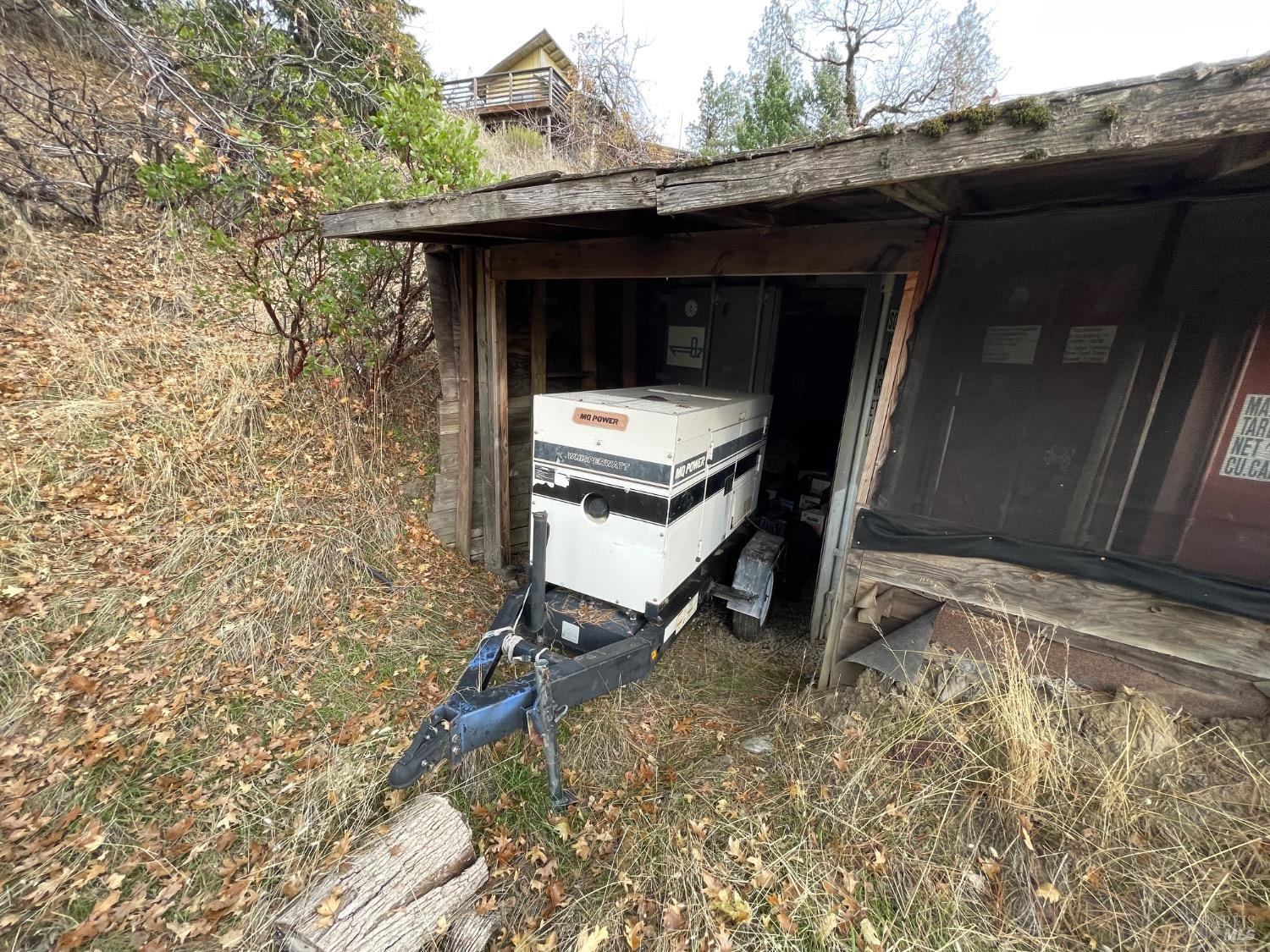 7601 Simmerly Road Laytonville, CA 95454 - Photo 18 of 30 a room with a bench and trees