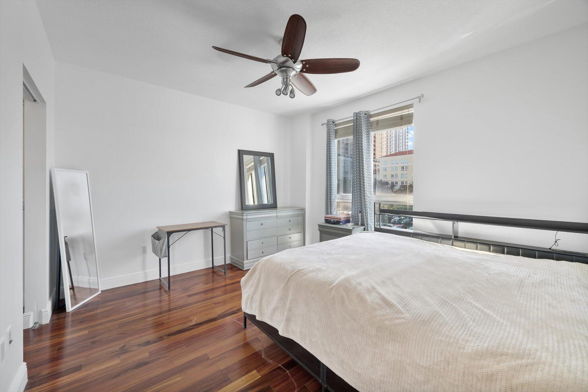 7270 Southwest 88th Street, Unit B203 Miami, FL 33156 - Photo 11 of 27 a bedroom with a bed and a chandelier