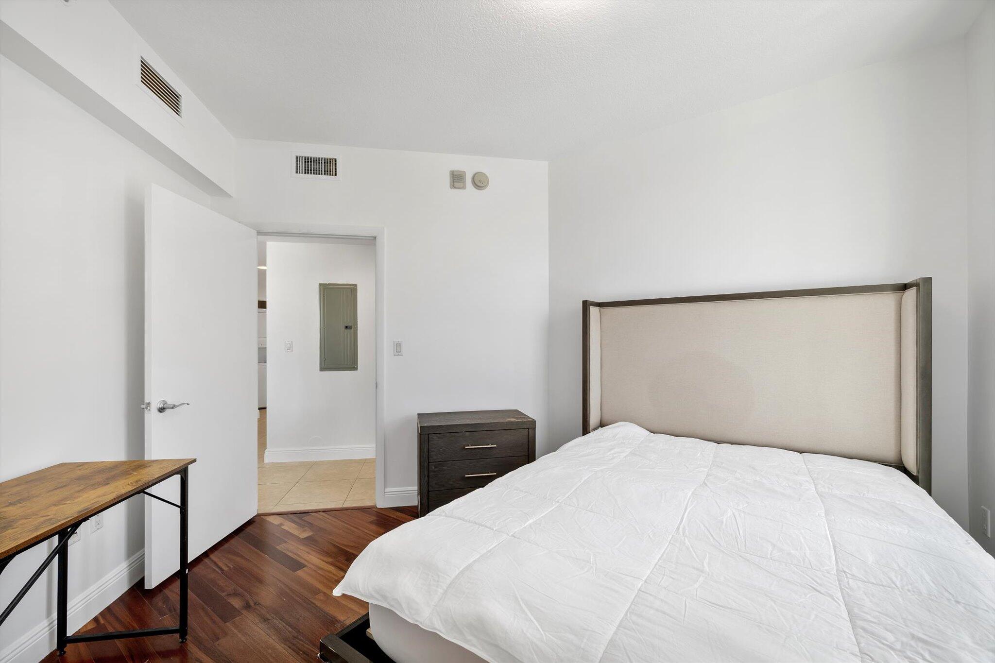 7270 Southwest 88th Street, Unit B203 Miami, FL 33156 - Photo 16 of 27 a bedroom with a bed and wooden floor