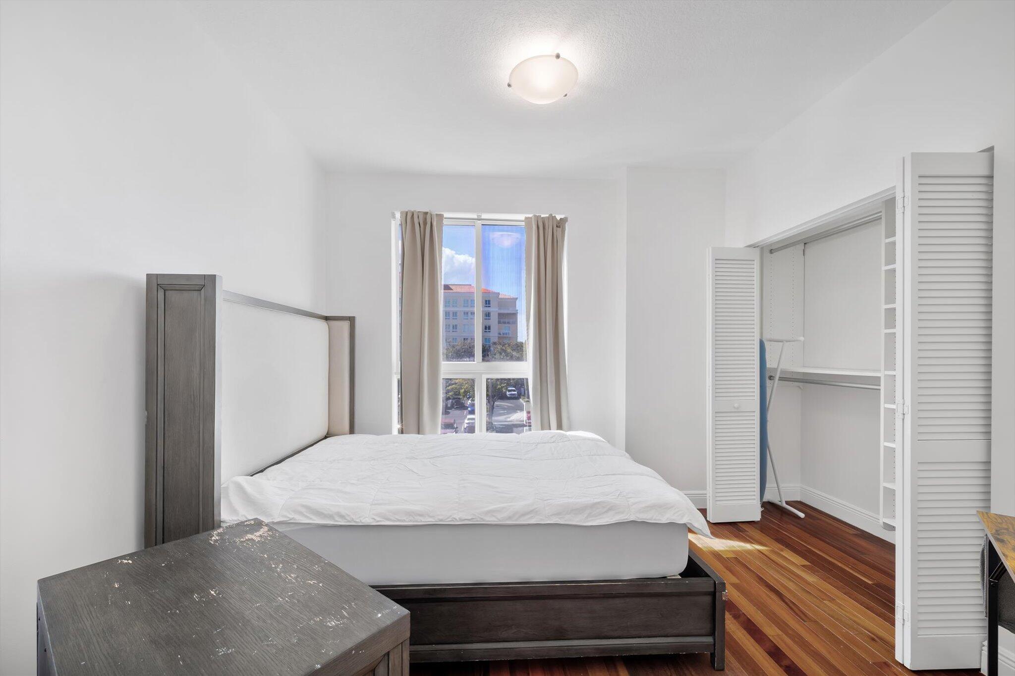 7270 Southwest 88th Street, Unit B203 Miami, FL 33156 - Photo 17 of 27 a bedroom with a bed and wooden floor