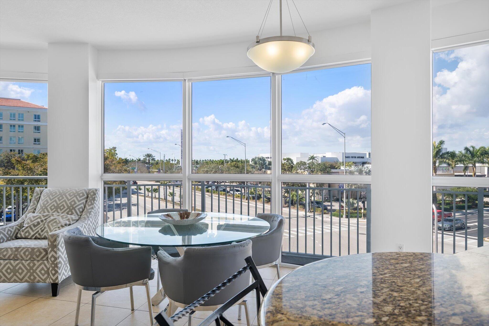 7270 Southwest 88th Street, Unit B203 Miami, FL 33156 - Photo 2 of 27 a view of a dining room with furniture wooden floor and chandelier