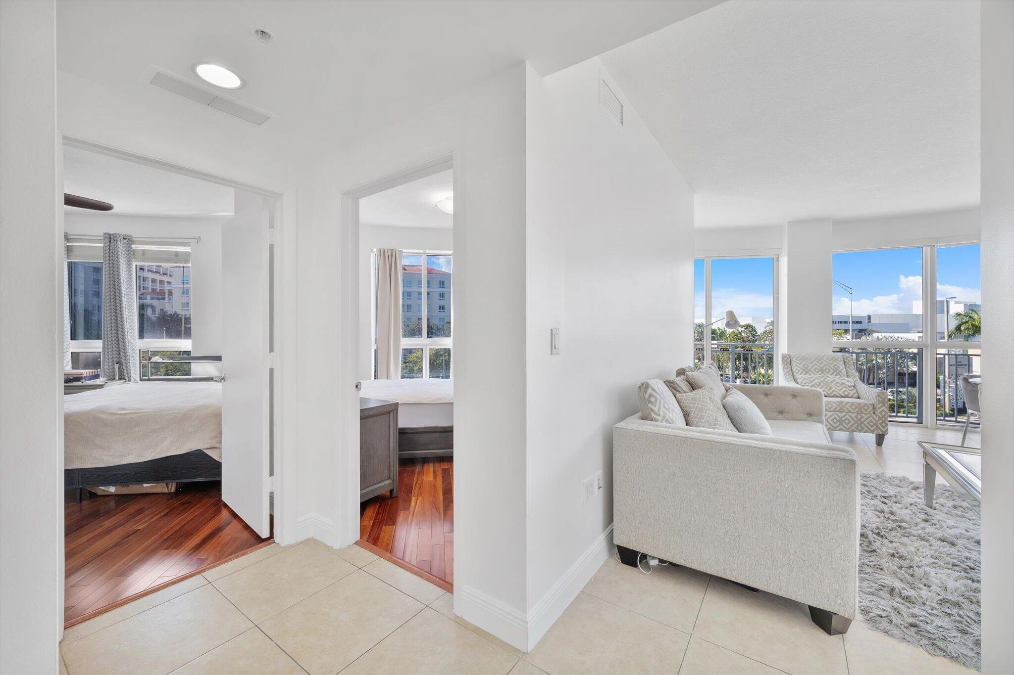 7270 Southwest 88th Street, Unit B203 Miami, FL 33156 - Photo 9 of 27 a living room with furniture a mirror and a table