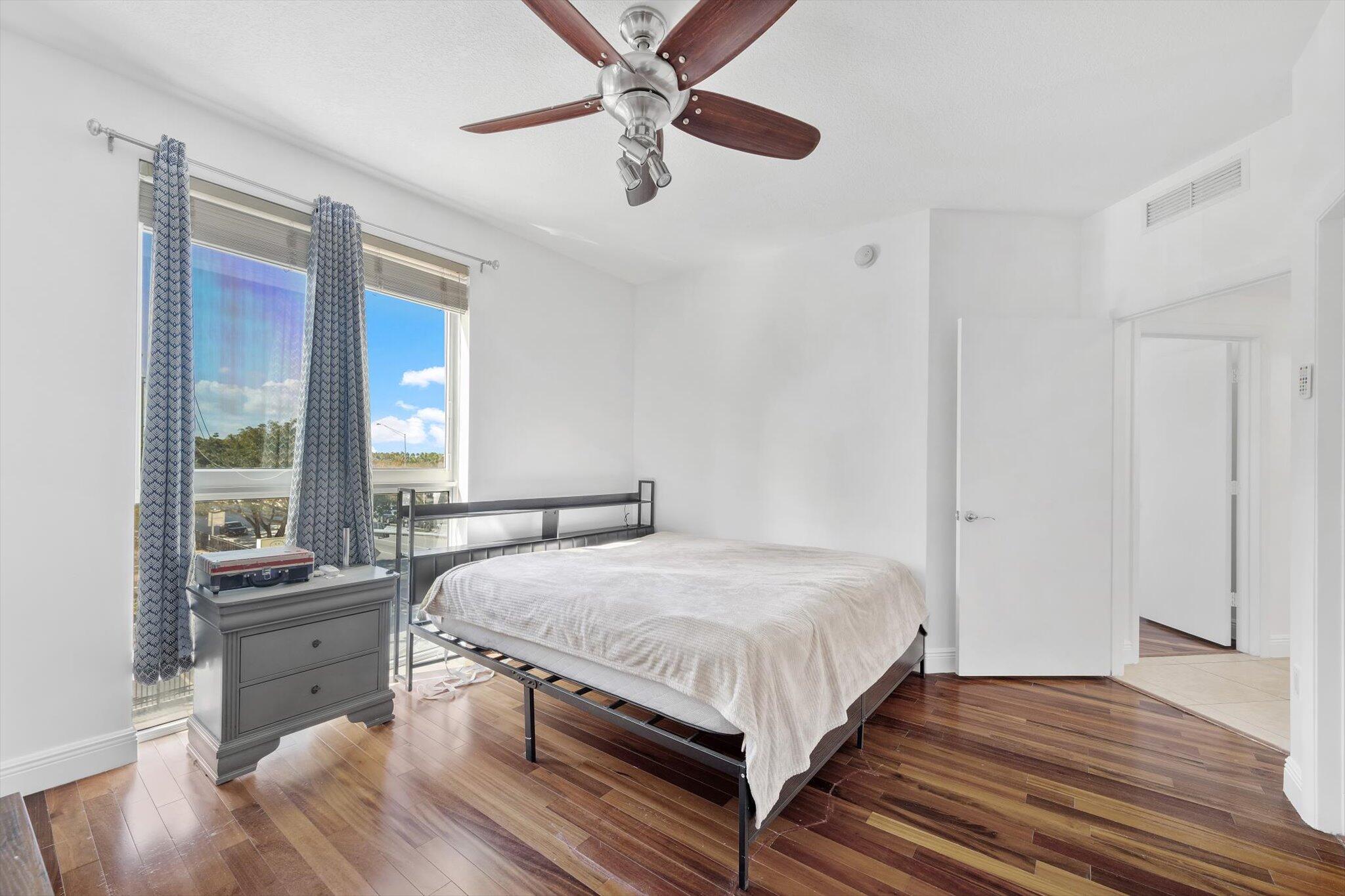 7270 Southwest 88th Street, Unit B203 Miami, FL 33156 - Photo 10 of 27 a bedroom with a bed and a large window