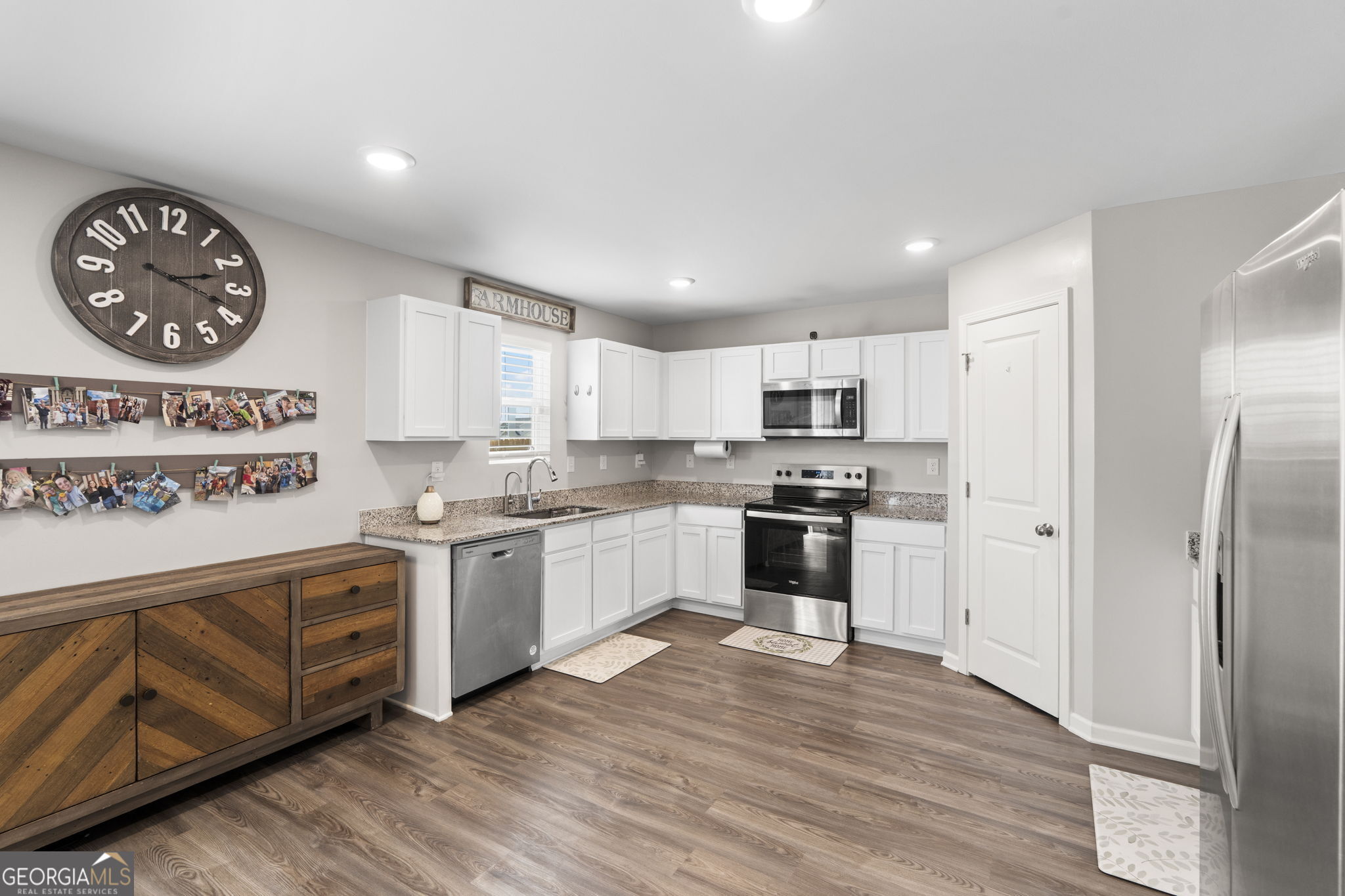 238 Isabella Way Byron, GA 31008 - Photo 12 of 37 a kitchen with granite countertop a refrigerator a stove a sink and a microwave