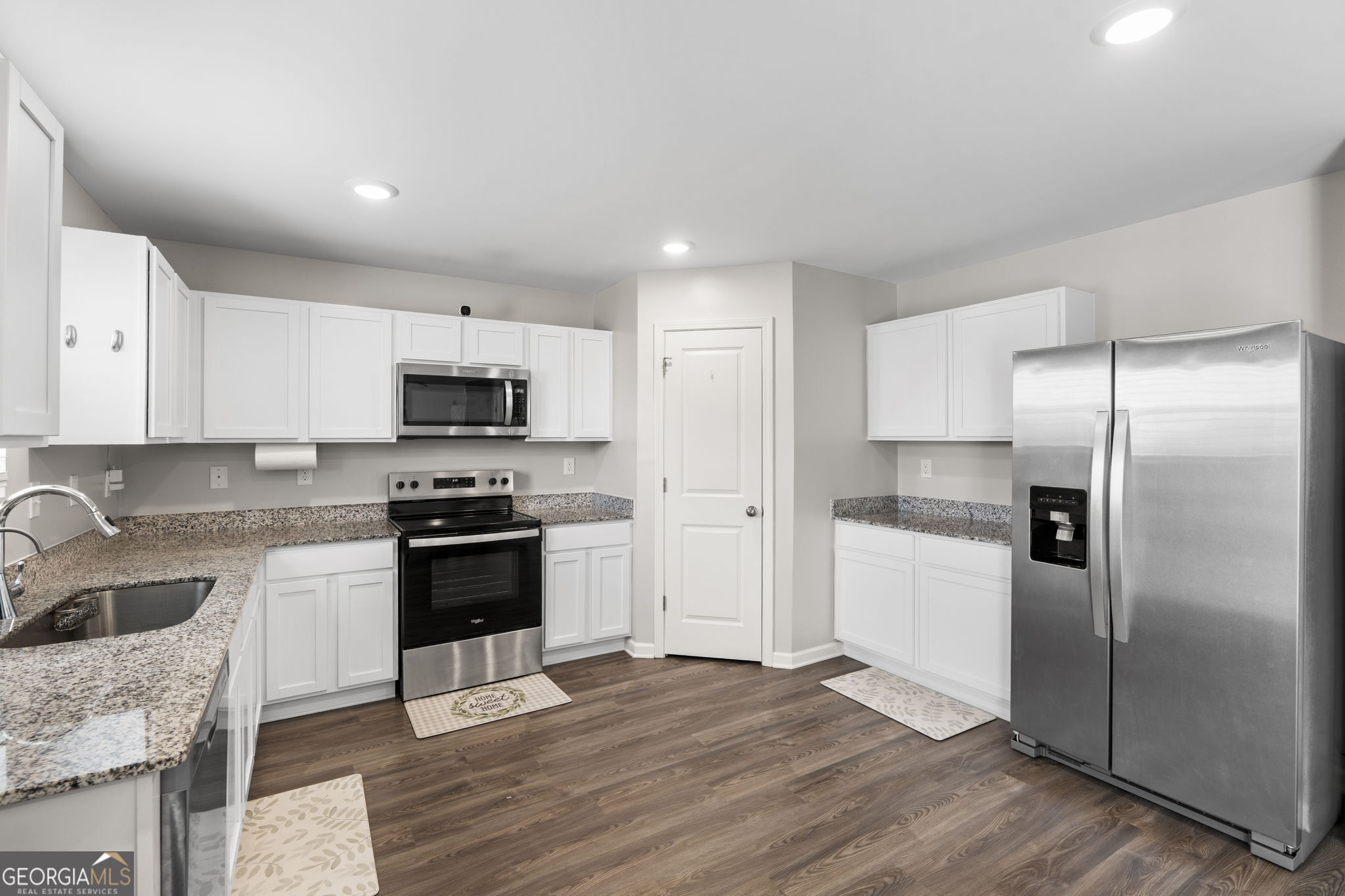 238 Isabella Way Byron, GA 31008 - Photo 15 of 37 a kitchen with stainless steel appliances granite countertop a refrigerator a sink dishwasher a stove with wooden cabinets and floors