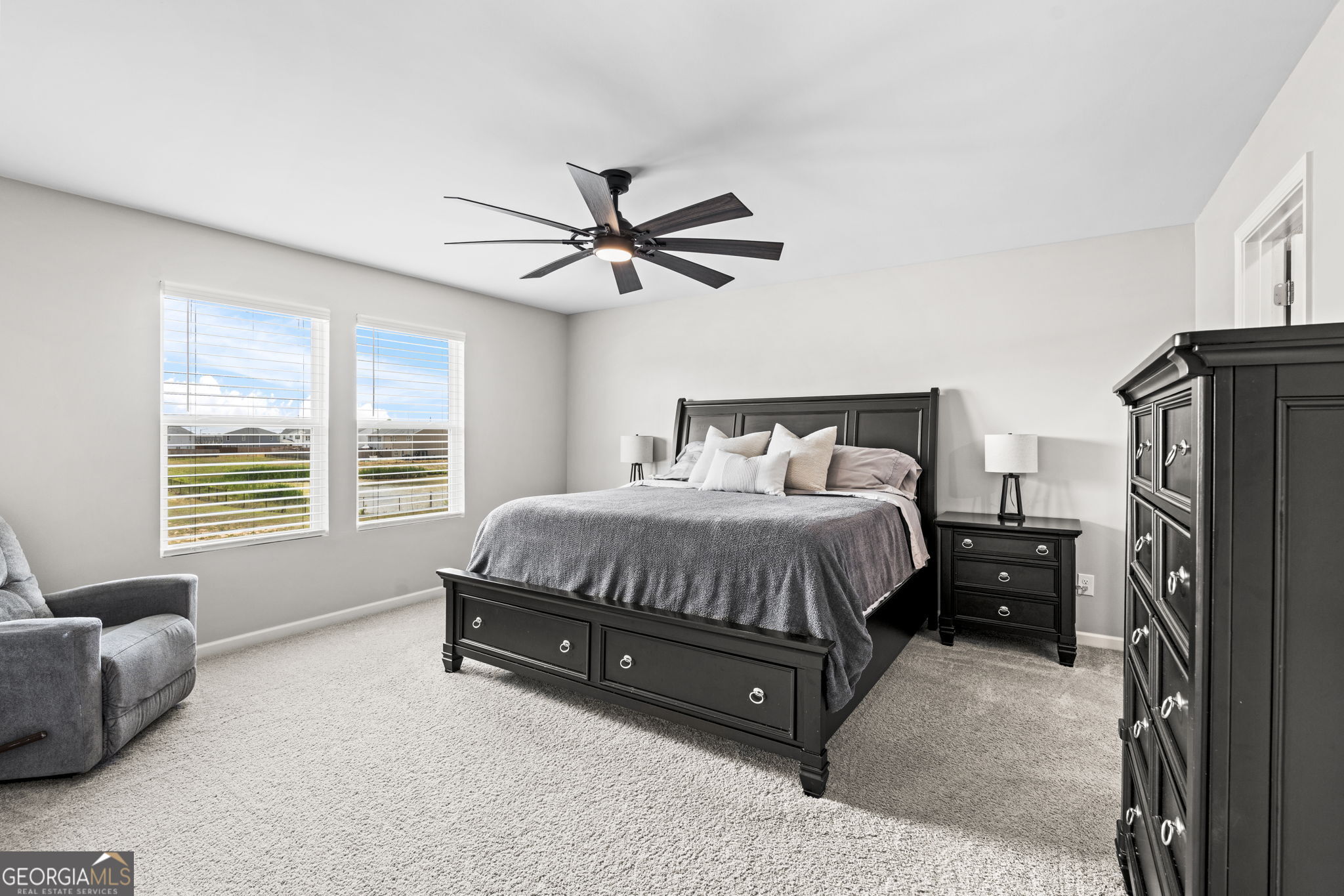 238 Isabella Way Byron, GA 31008 - Photo 26 of 37 a spacious bedroom with a bed a couch and a larger window