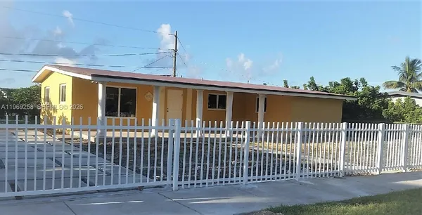 a front view of a house with a fence