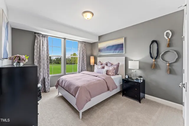 a bed sitting in a bedroom next to a window