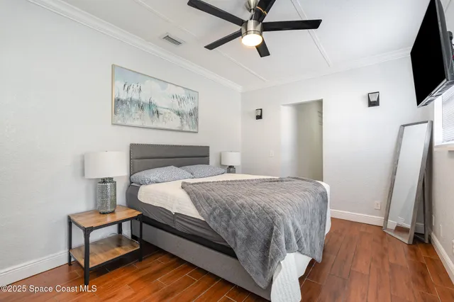 a bedroom with a bed and a flat screen tv