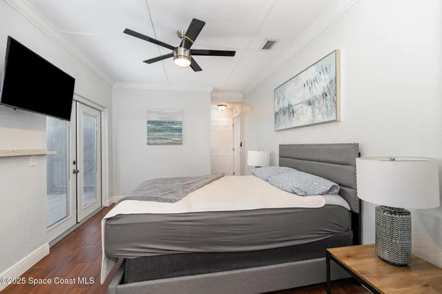 a bedroom with a bed and a flat screen tv