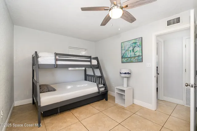 a bedroom with a bed and a ceiling fan