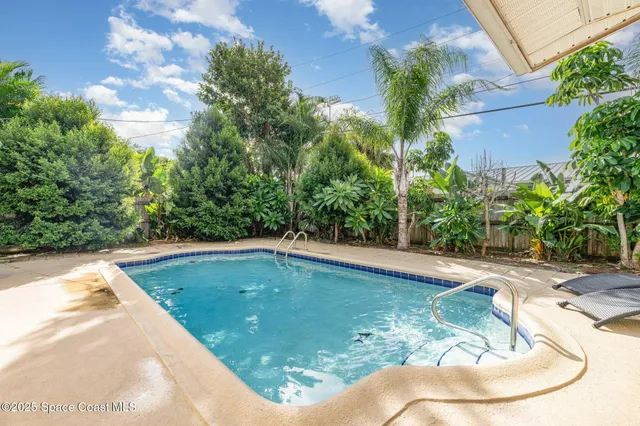 a view of a swimming pool with a yard