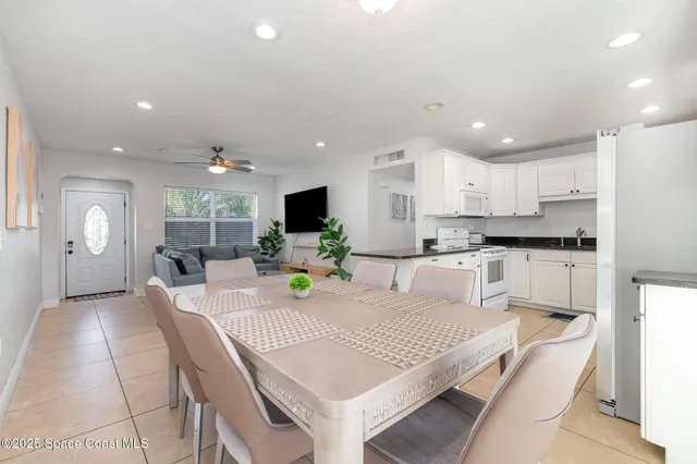 a kitchen with kitchen island granite countertop a sink a center island stainless steel appliances and cabinets