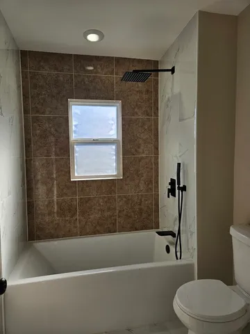 a bathroom with a toilet and a bathtub