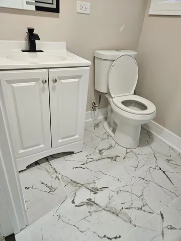 a bathroom with a sink a toilet and a mirror