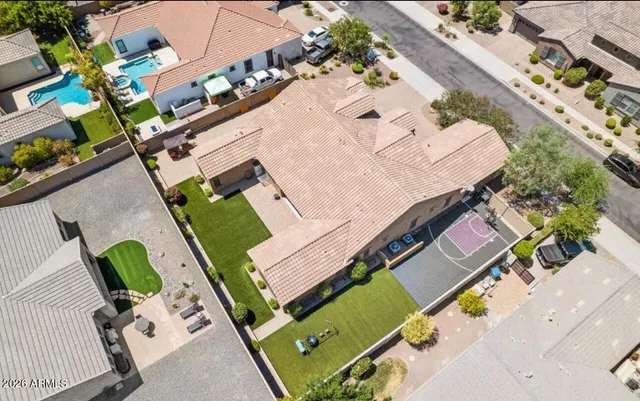 an aerial view of a house with a yard and potted plants