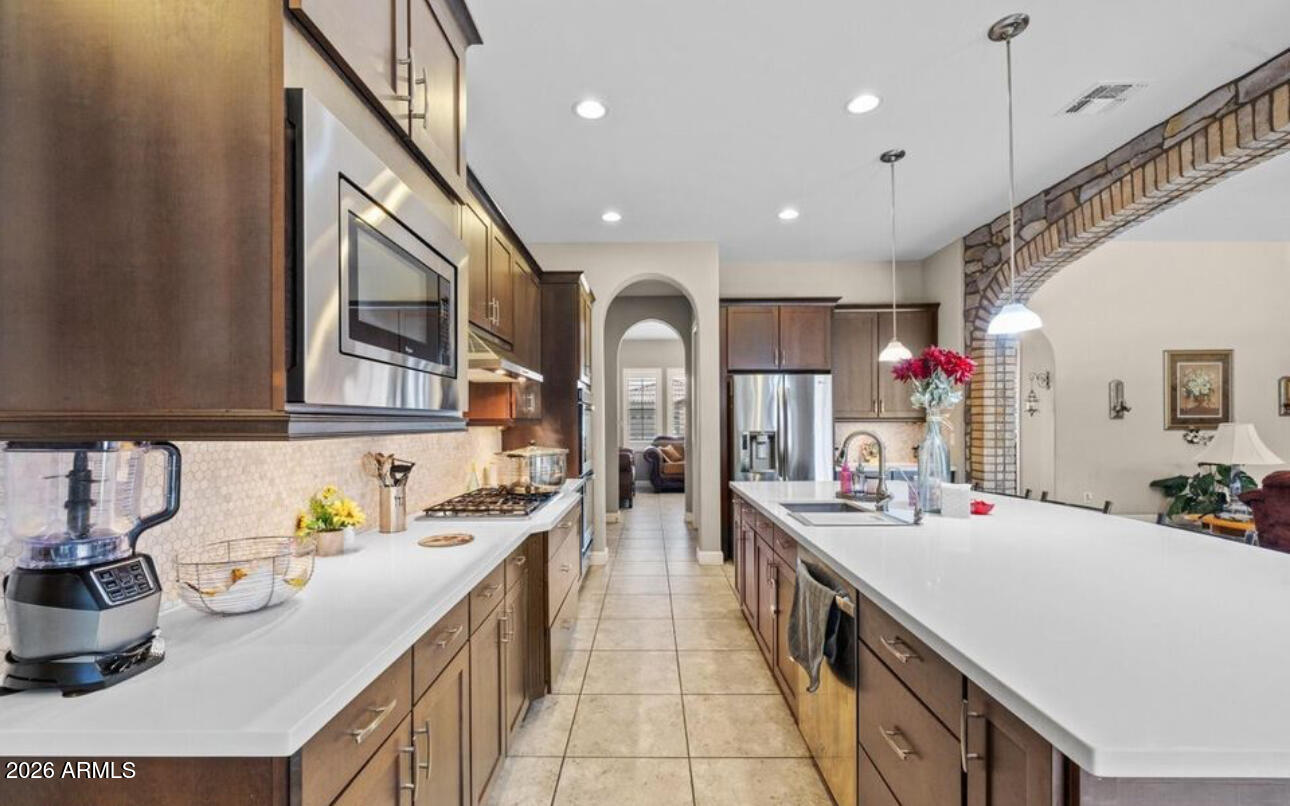 2915 East Constance Way Phoenix, AZ 85042 - Photo 19 of 47 a kitchen with kitchen island granite countertop lots of counter top space