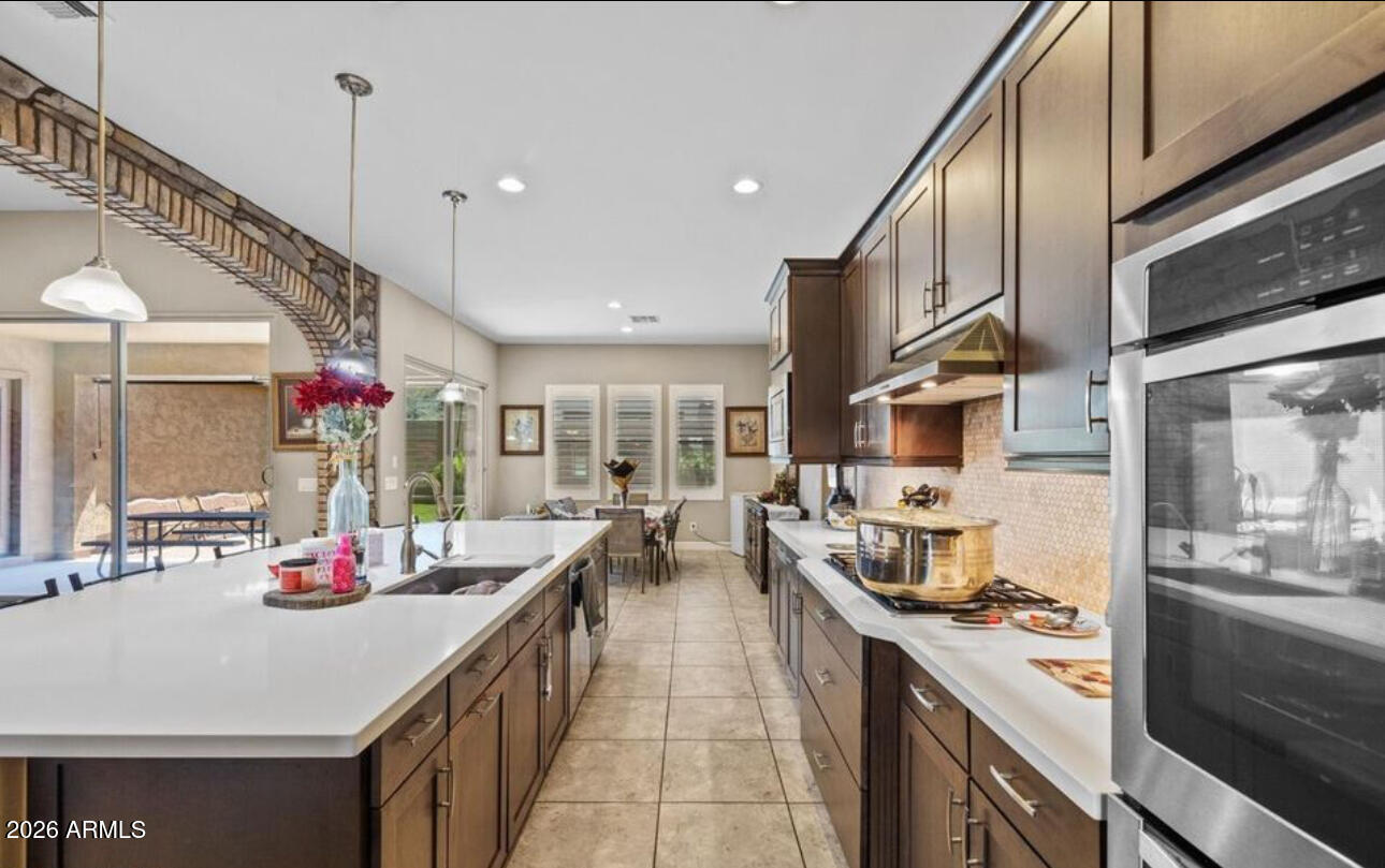 2915 East Constance Way Phoenix, AZ 85042 - Photo 20 of 47 a kitchen with counter space a sink appliances and cabinets