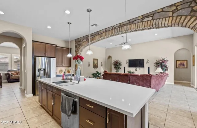 a kitchen with stainless steel appliances kitchen island granite countertop a sink and cabinets