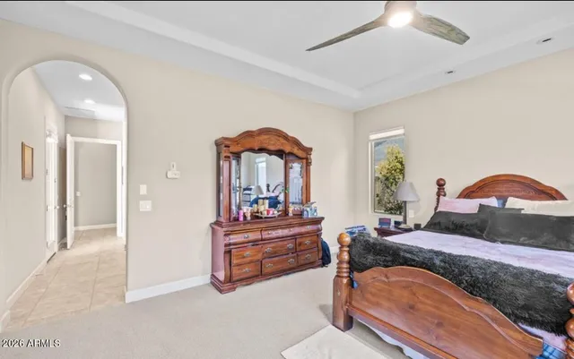a bedroom with bed and a chandelier