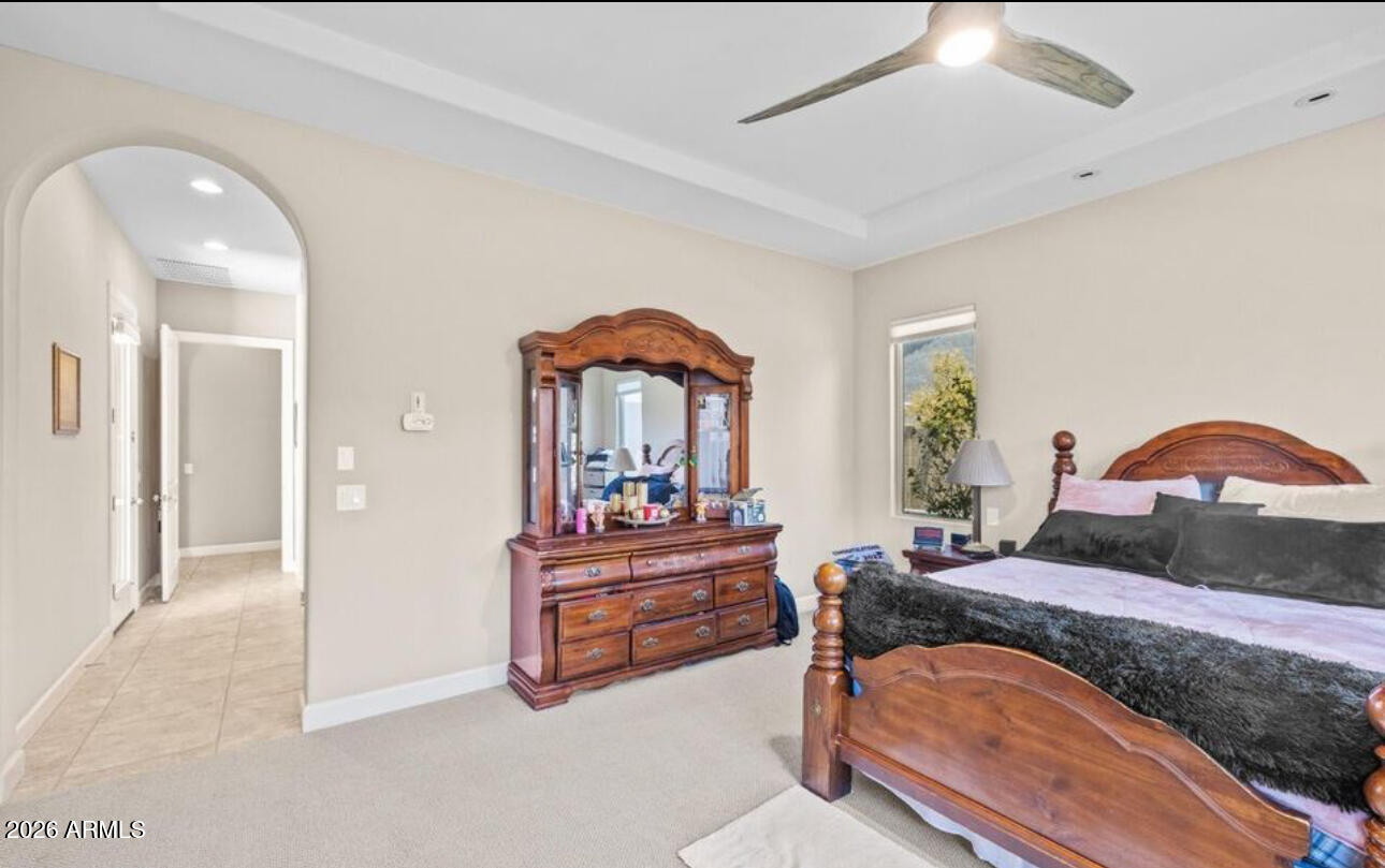 2915 East Constance Way Phoenix, AZ 85042 - Photo 24 of 47 a bedroom with bed and a chandelier