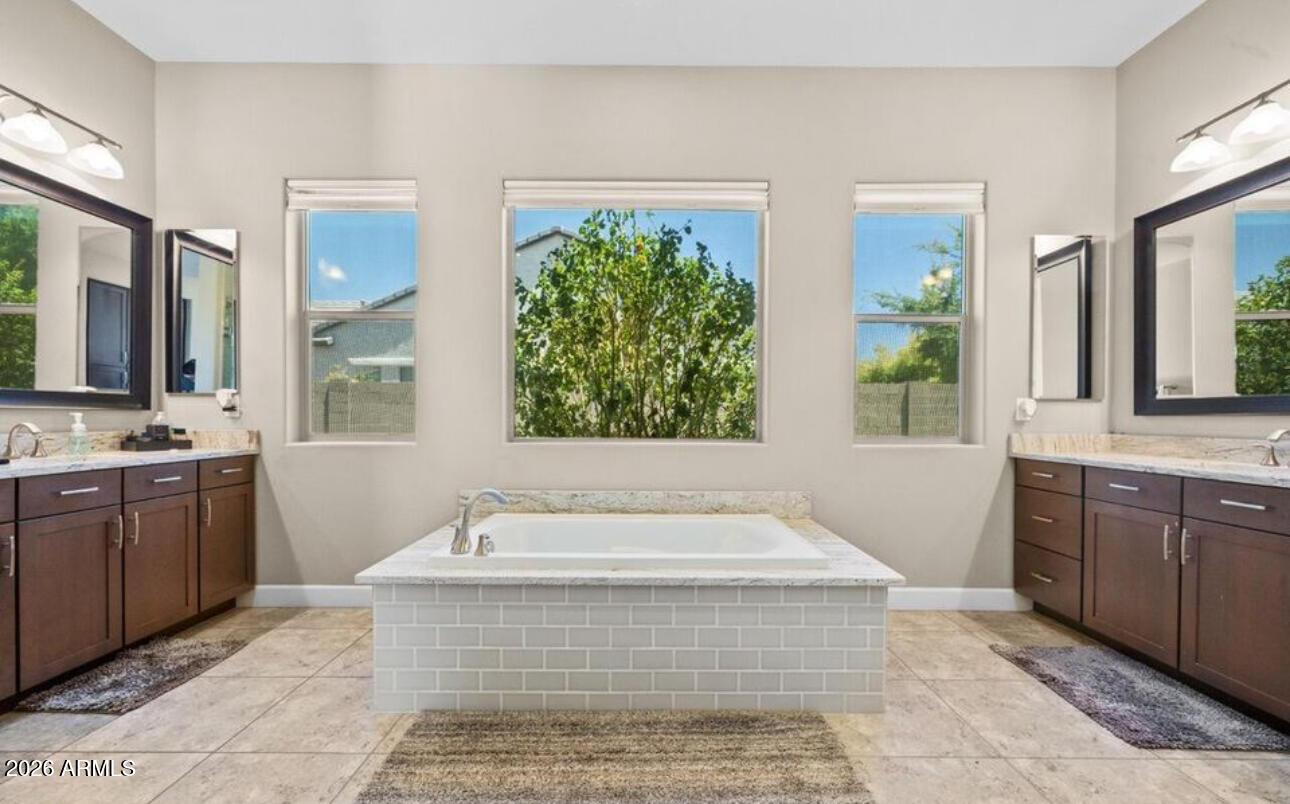 2915 East Constance Way Phoenix, AZ 85042 - Photo 26 of 47 a spacious bathroom with a tub sink and mirror