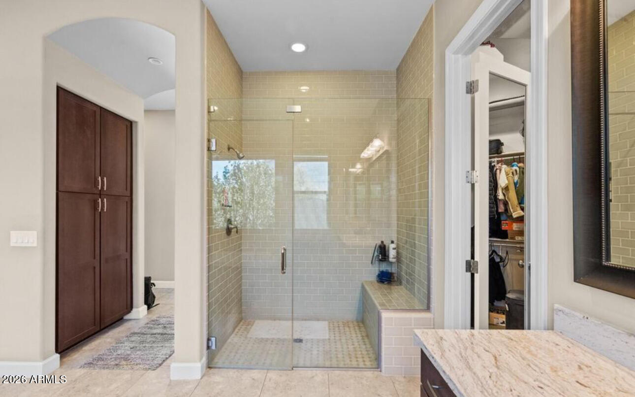 2915 East Constance Way Phoenix, AZ 85042 - Photo 27 of 47 a bathroom with a granite countertop sink a shower and a mirror