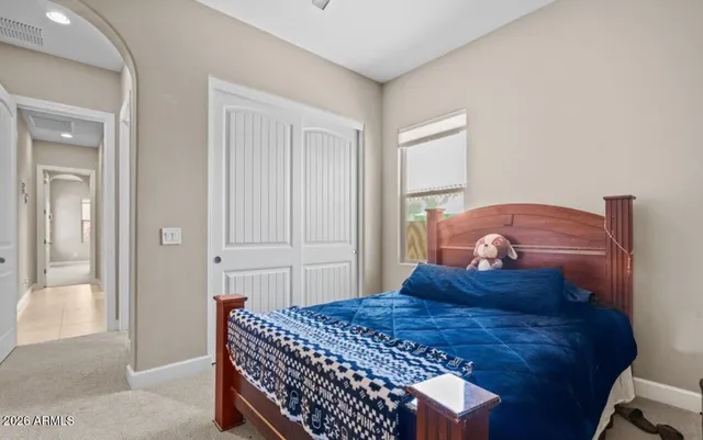 a bedroom with a bed and a mirror