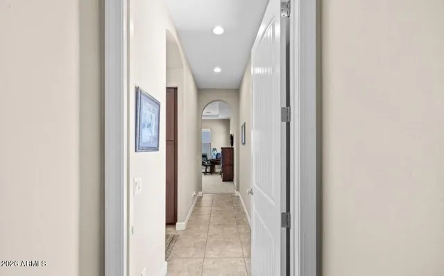 a view of a hallway with wooden shelves