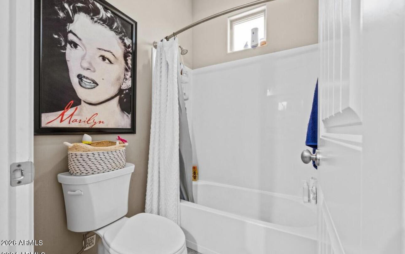 2915 East Constance Way Phoenix, AZ 85042 - Photo 33 of 47 a white toilet sitting next to a bathroom sink