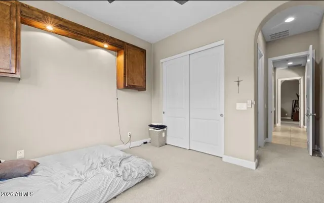 a bedroom with a bed and view of bathroom