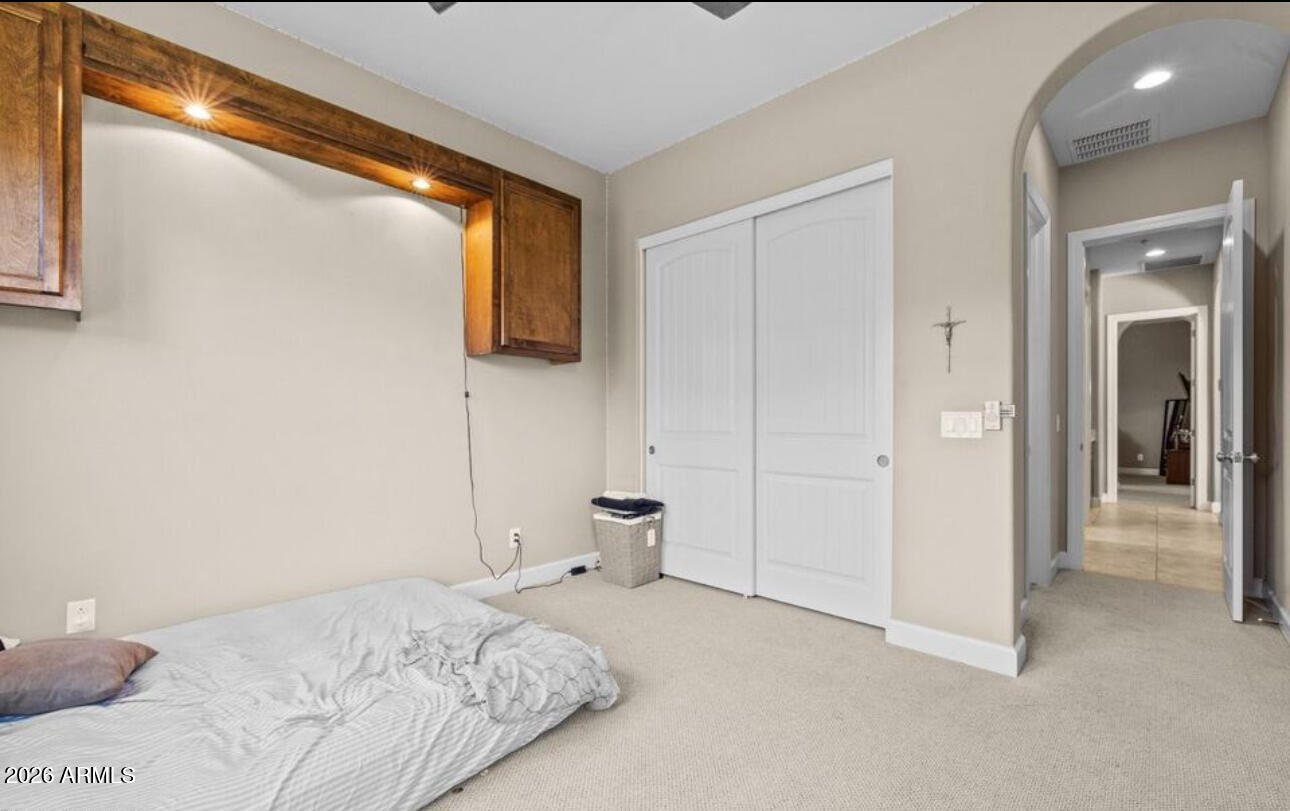 2915 East Constance Way Phoenix, AZ 85042 - Photo 36 of 47 a bedroom with a bed and view of bathroom