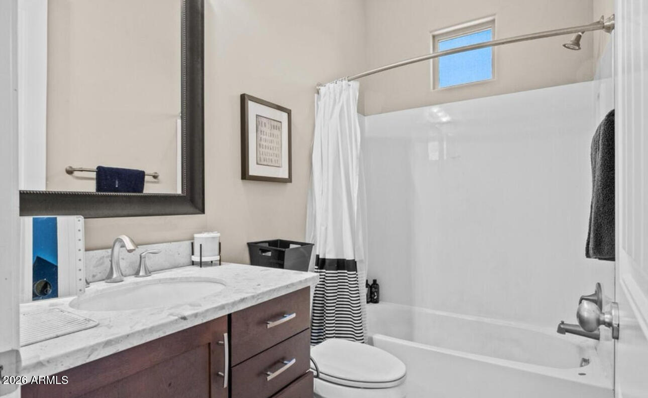 2915 East Constance Way Phoenix, AZ 85042 - Photo 37 of 47 a bathroom with a granite countertop sink toilet and shower