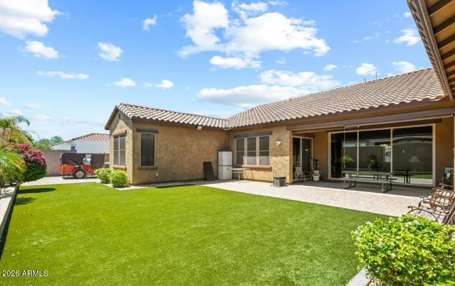 a front view of a house with sitting area and garden