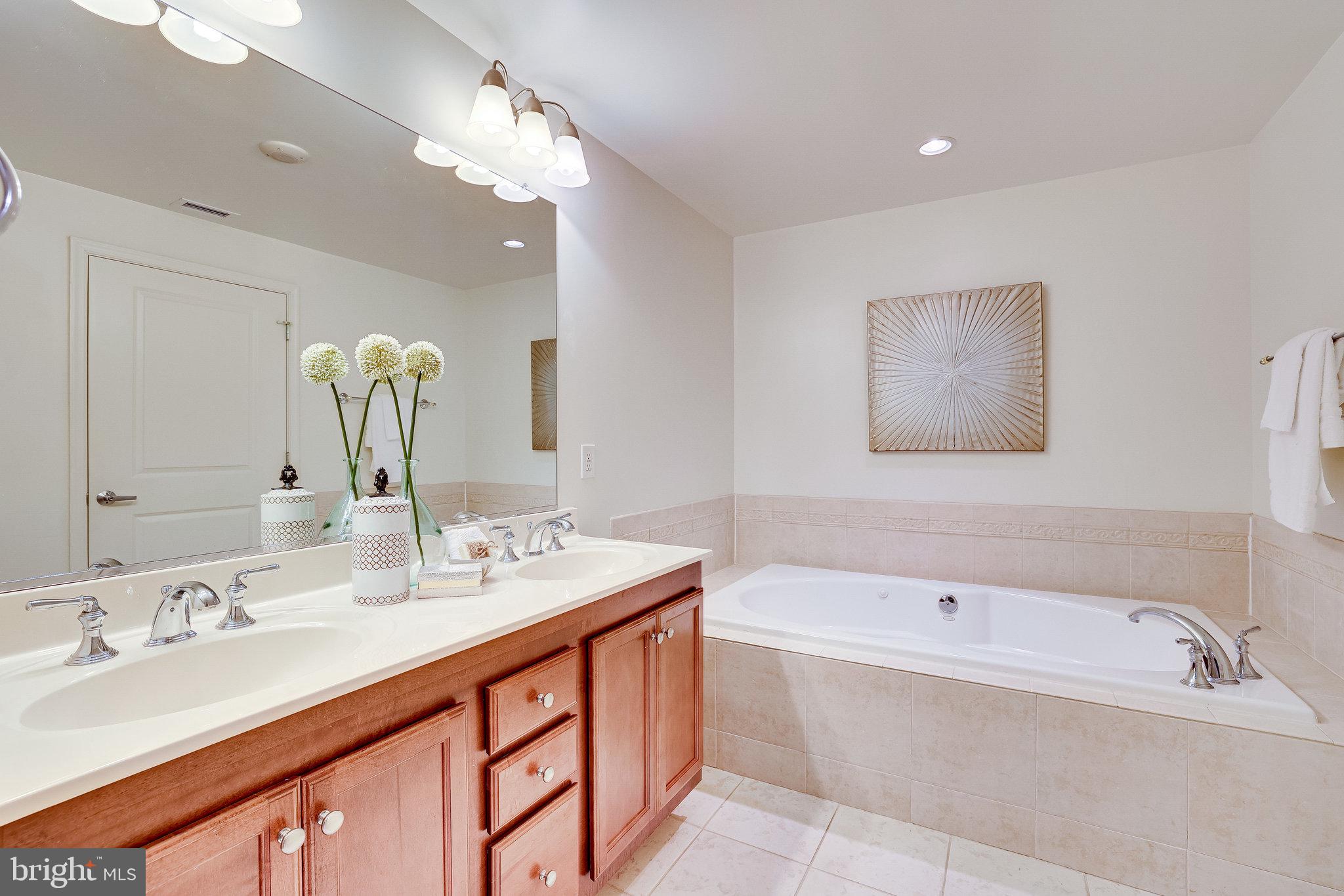 1830 Fountain Drive, Unit 1008 Reston, VA 20190 - Photo 20 of 42 Primary bath has a dual sink vanity.