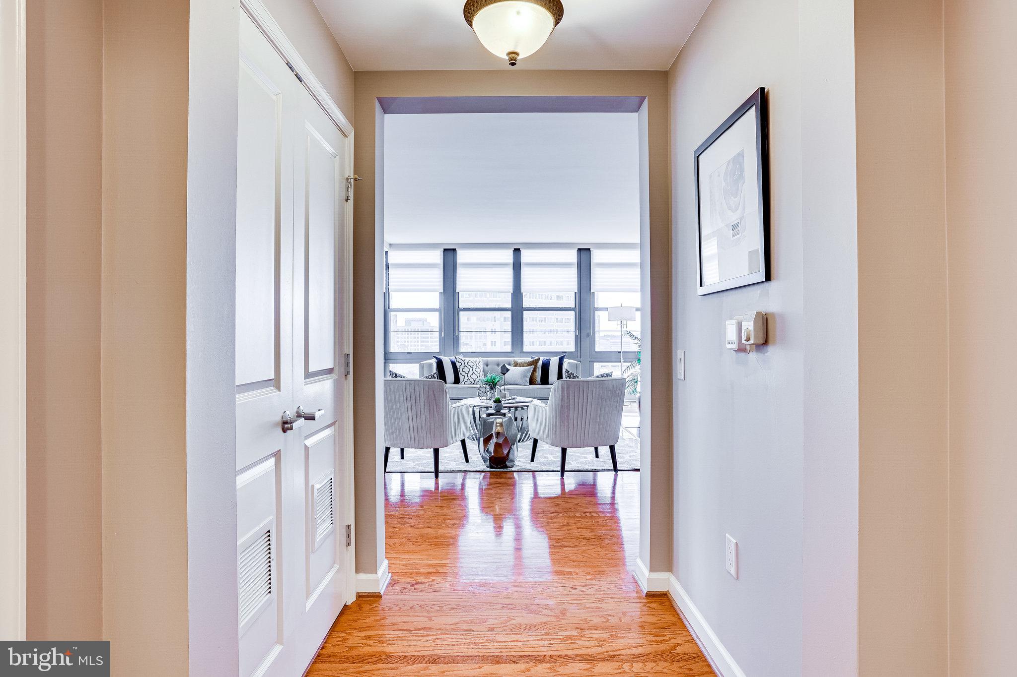 1830 Fountain Drive, Unit 1008 Reston, VA 20190 - Photo 7 of 42 White oak floors lead you into the living room.