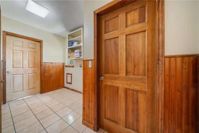 a dining room with furniture a chandelier and window