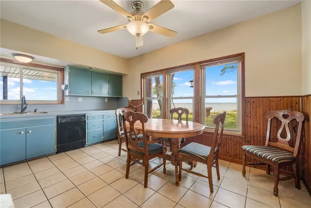 a view of a house with a yard and basketball court