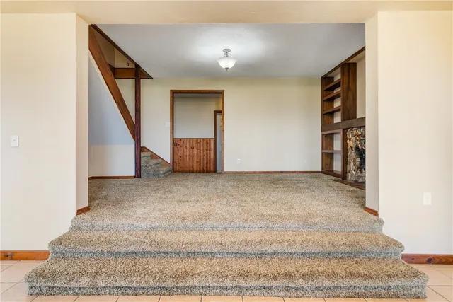 a view of an empty room with stairs and ventilation