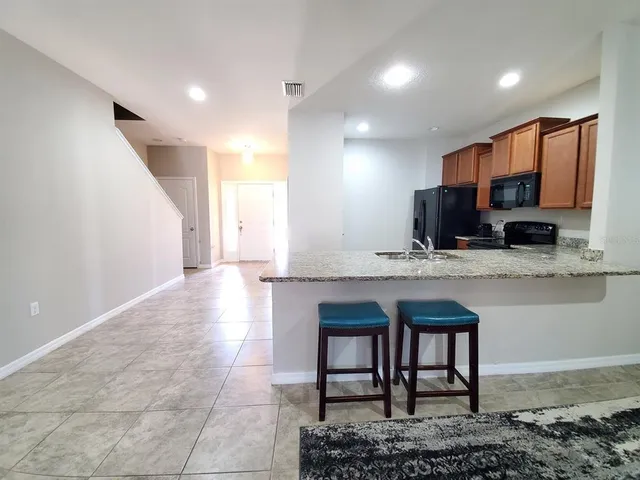 a view of kitchen with furniture and a window
