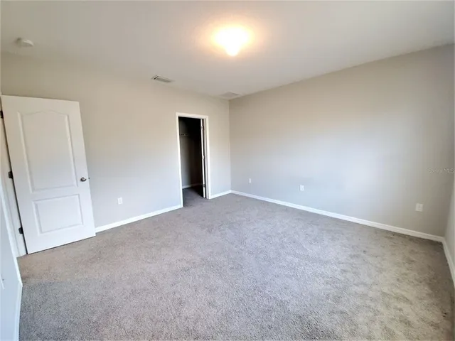 a view of an empty room and a window