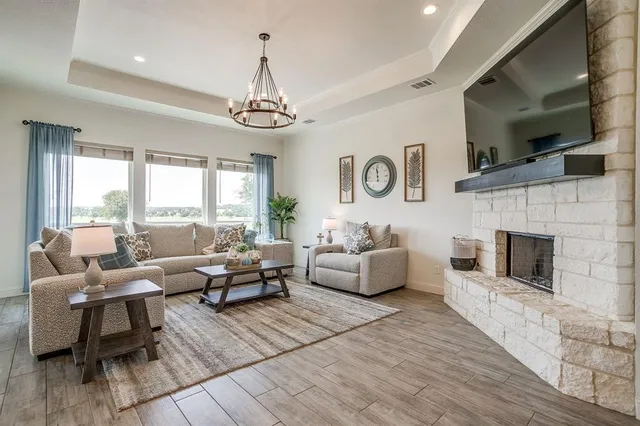 a living room with fireplace furniture and a flat screen tv