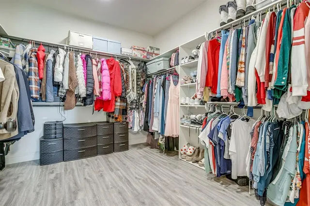 a view of walk in closet with clothes
