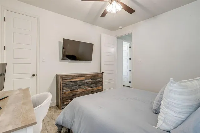 a bedroom with a bed and a flat screen tv