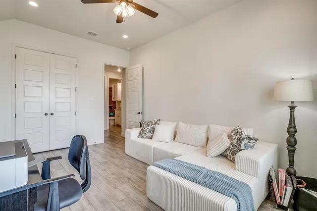 a living room with furniture a lamp and a chandelier